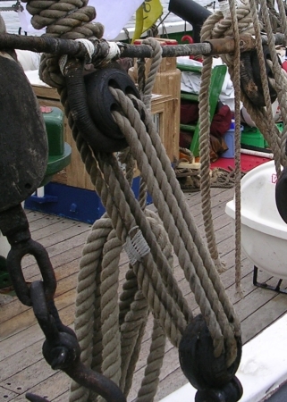 A photograph of a pair of Triple Deadeyes in use onboard a square rigged sailing ship.