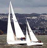 Sloops (actually knockabouts) racing - the sailboat on the right has a Fractional Rig and the larger vessel (sailboat) has a Masthead Rig. See sailboating terms and nomenclature below.
